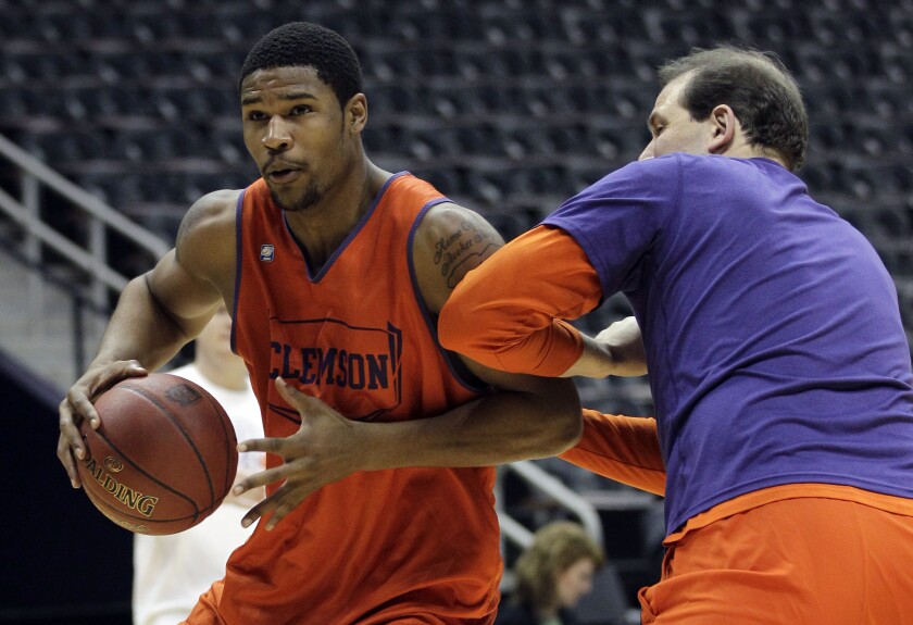 Clemson's Devin Booker moves around assistant coach Mike Winiecki.