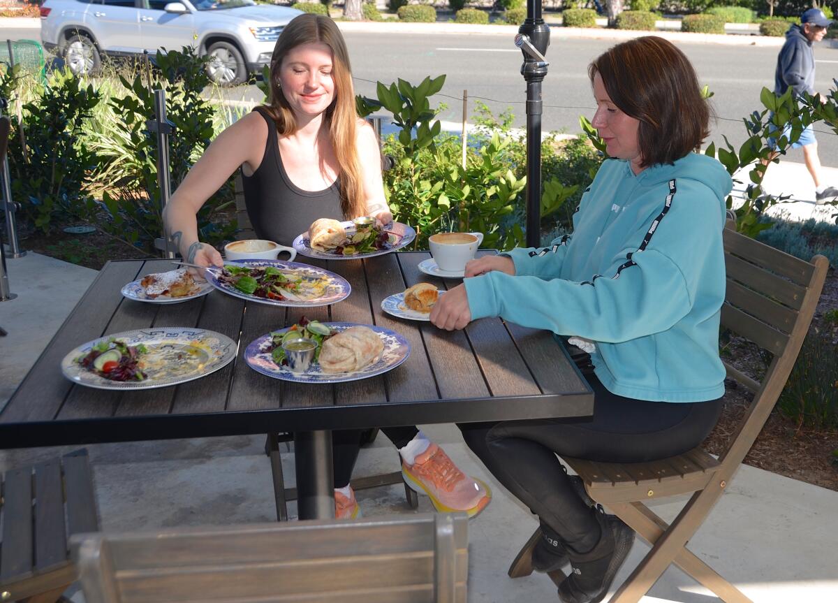 Sierra Tolis and Michelle Upton enjoy pastries and coffee on the outdoor patio at Juliette's Cafe.
