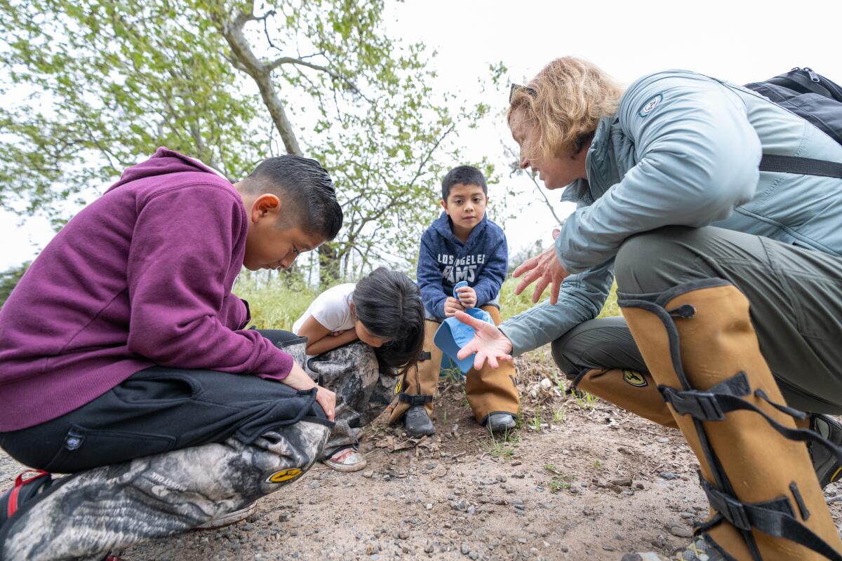 Students from the Delhi Center examine the soil moisture as part of a data collection field trip in April.