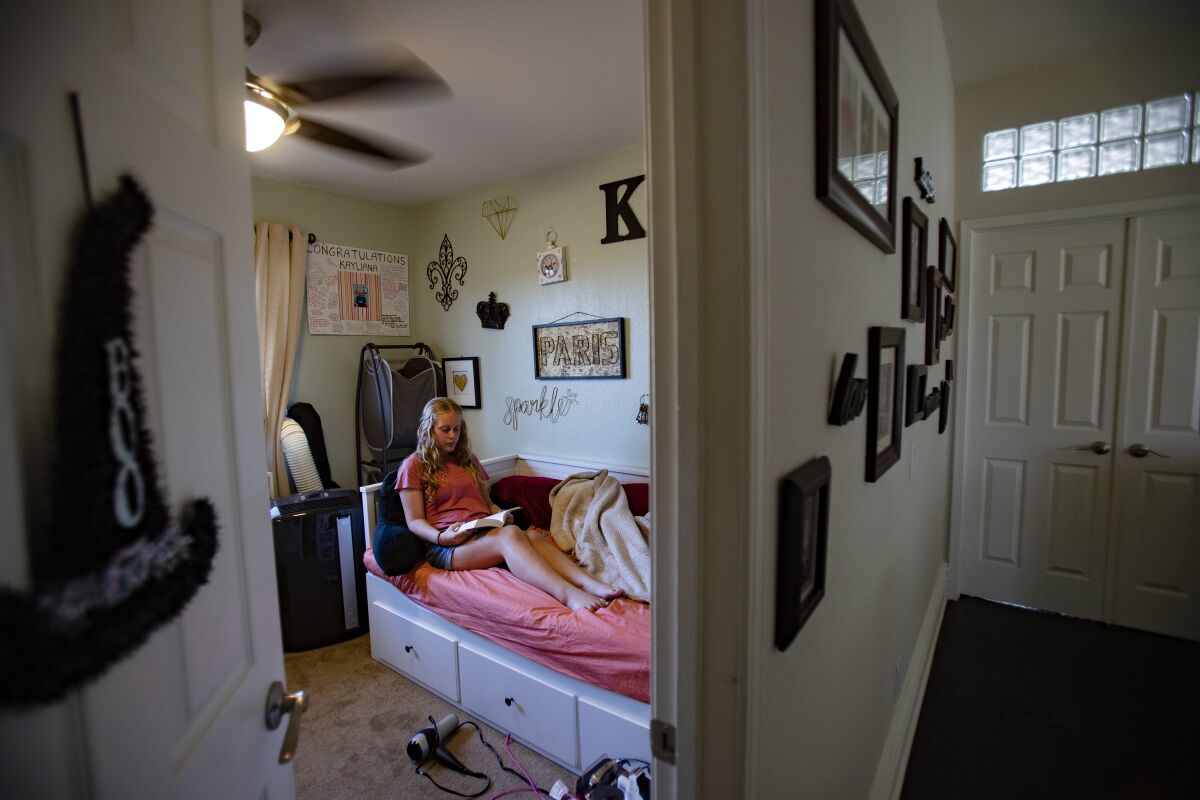 Kayliana Bride-Shoemaker,13, spends time reading in her room after spending a month living at the new chronic pain clinic at Rady's Children Hospital in San Diego. She is now home in Riverside.