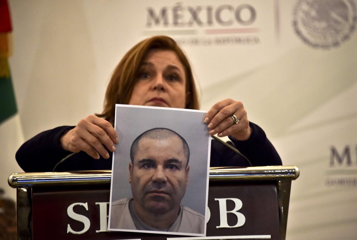 Mexican Atty. Gen. Arely Gomez shows a picture of fugitive drug lord Joaquin "El Chapo" Guzman during a news conference in Mexico City on July 13, 2015.