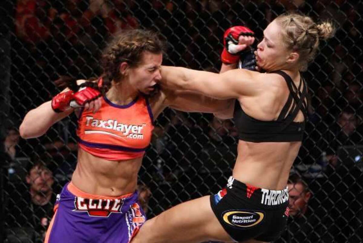 Ronda Rousey, right, trades blows with Miesha Tate during the Strikeforce event in Columbus, Ohio, on March 3.