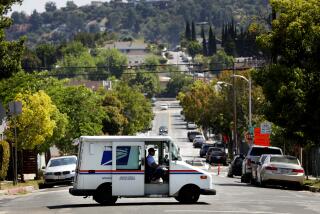 HIGHLAND PARK-CA-JUNE 2, 2023: A mail truck passes Avenue 50 in Highland Park on June 2, 2023. Many residents in the area have been receiving unwanted Uber Eats orders. (Christina House / Los Angeles Times)