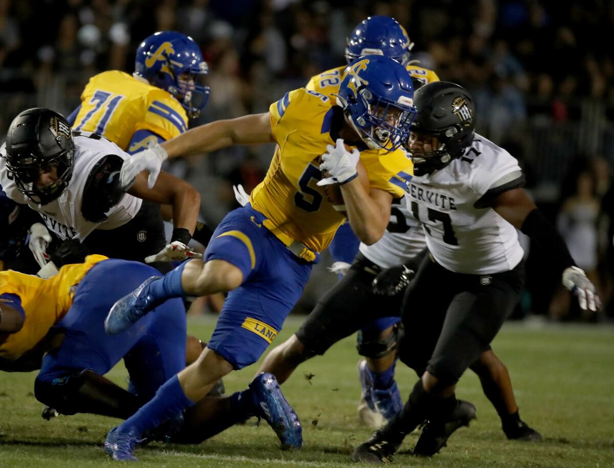 Bishop Amat running back Aiden Ramos makes a short gain against Servite in a 2021 game.