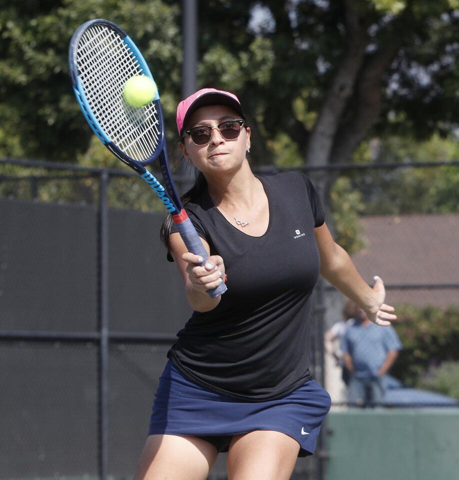 Crescenta Valley's Melissa Muradoglu approaches the net to hit the ball into play in the Pacific League girls' tennis prelims at Burroughs High School on Monday, October 22, 2018.