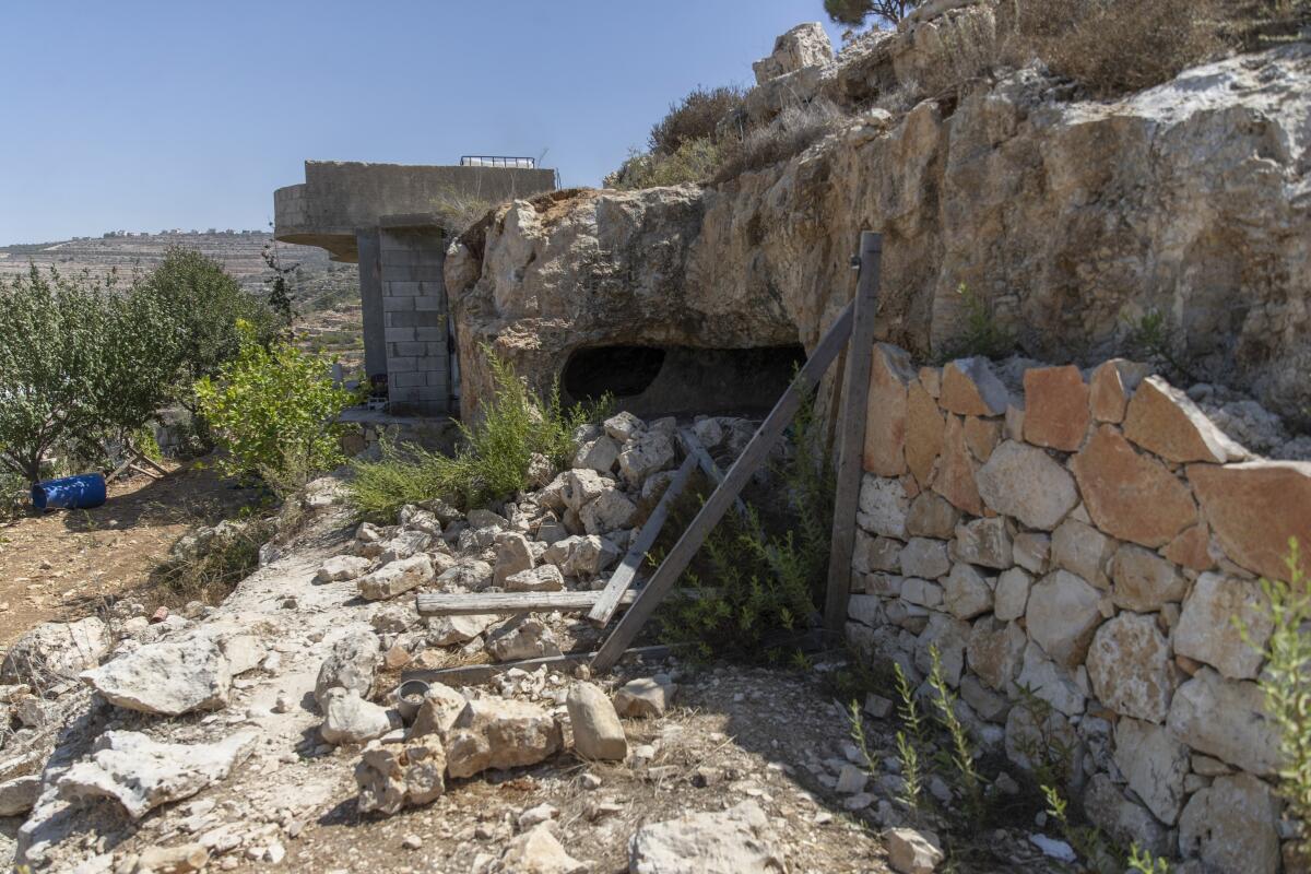 A stone wall and debris on the ground outdoors.