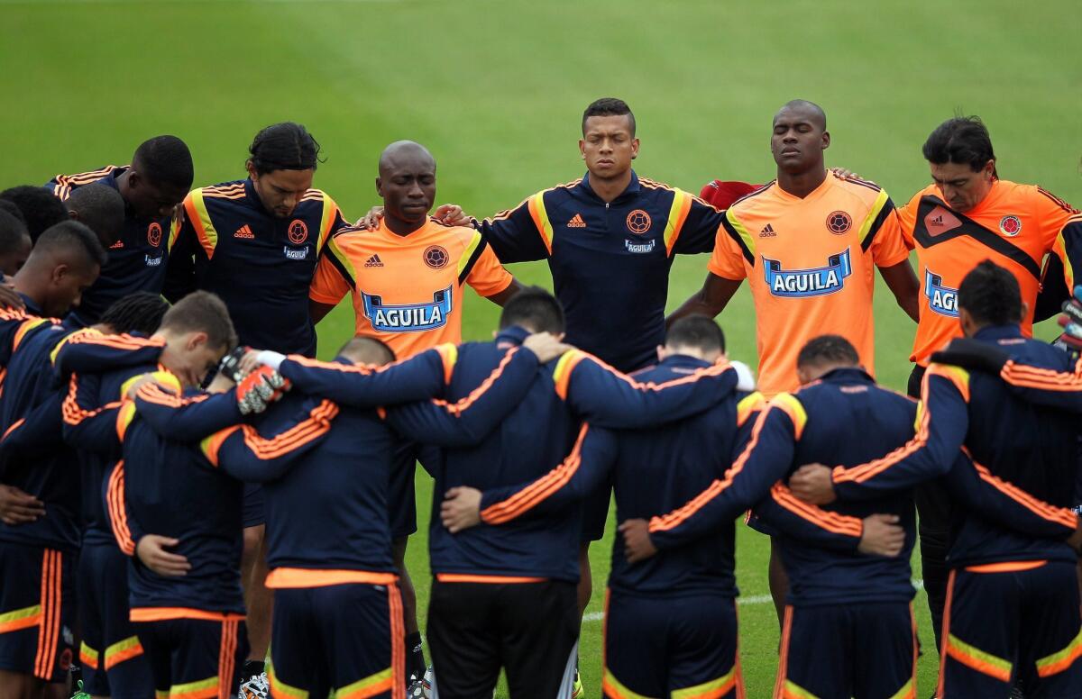 The Colombia soccer team circles up before a training session in Brazil.