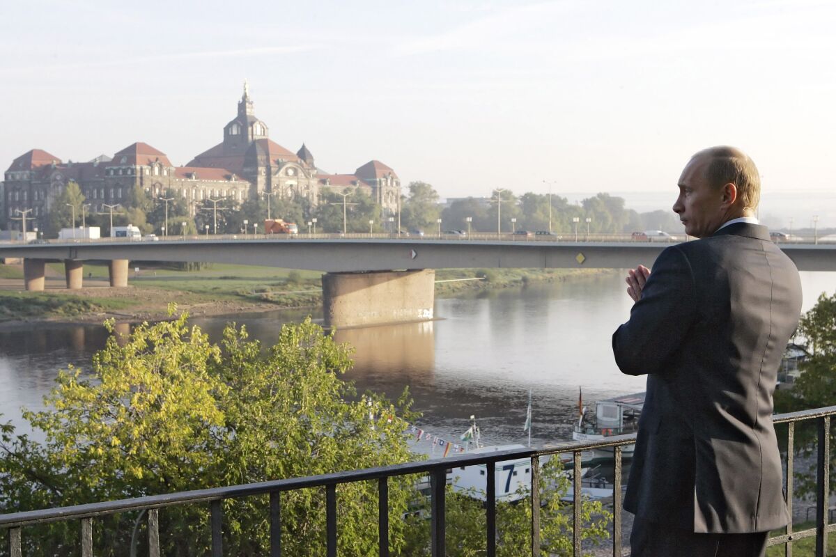 Russian President Vladimir Putin stands on the embankment of the Elbe River