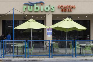 Los Angeles, CA - June 03: Passerby's look in the windows of Rubio's Costal Grill on Lincoln Blvd in Los Angeles, CA. (Zoe Cranfill / Los Angeles Times)