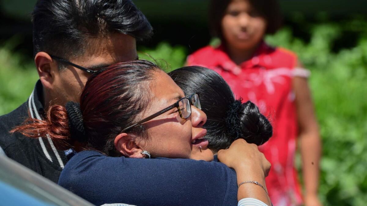Women hug after the explosions that tore through several fireworks factories in Tultepec, Mexico, on July 5, 2018.