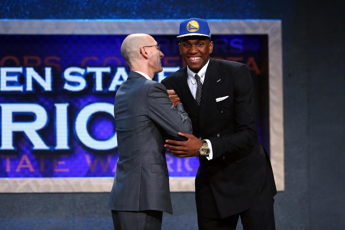 UCLA forward Kevon Looney meets NBA Commissioner Adam Silver after being selected by the Golden State Warriors with the 30th overall pick in the 2015 NBA Draft.