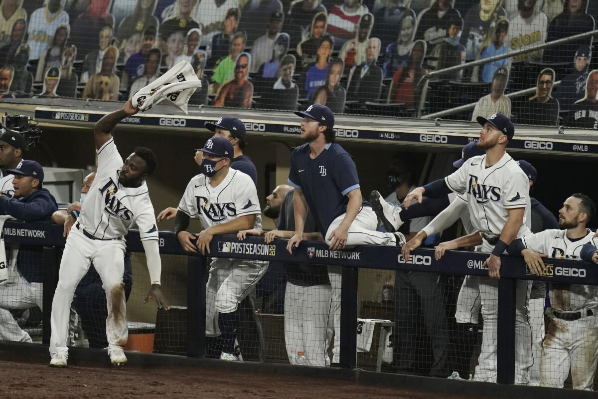 Tampa Bay Rays players react to a sacrifice fly.