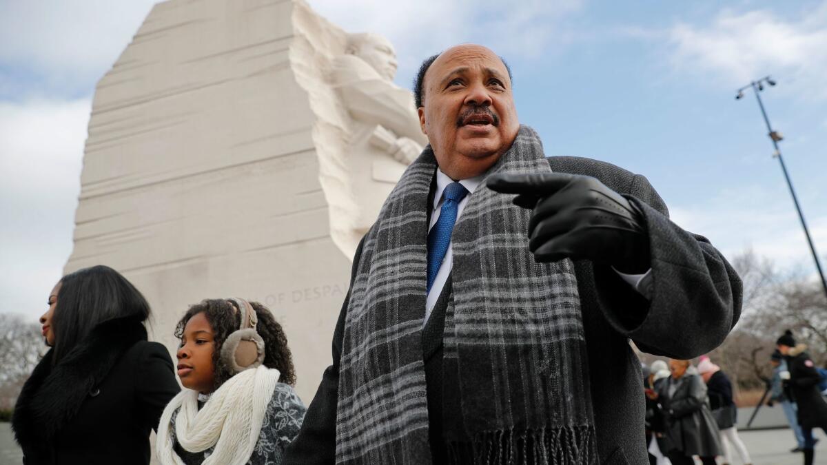 Martin Luther King III, right, with his wife, Arndrea Waters, and daughter Yolanda, 9, center, visit the Martin Luther King Jr., Memorial on the National Mall in Washington on Monday.