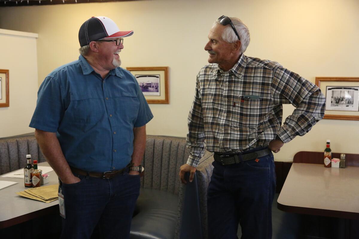 Mayor Dave Noerr, right, chats with Jeff Joseph, one of many Taft. Calif., residents who works in the oil industry.