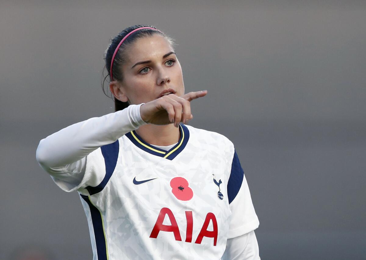 Alex Morgan points during a match