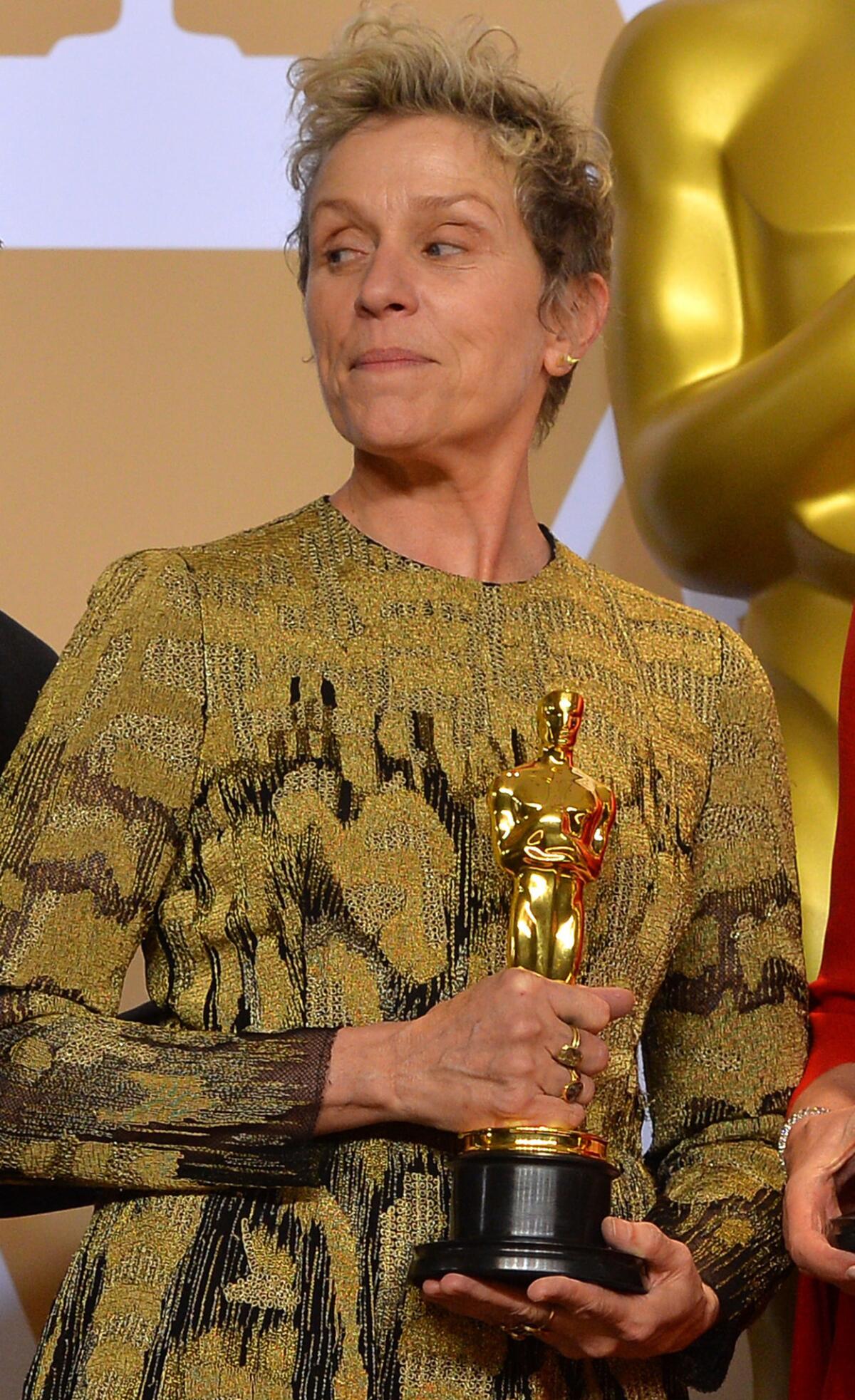 Best actress winner Frances McDormand holds her Oscar backstage at the 90th Academy Awards in 2018.