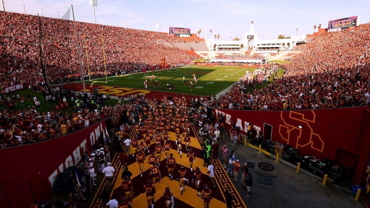 USC takes the field before their game against Texas at the Coliseum on Saturday. The game was a sellout with over 80,000 in attendance.