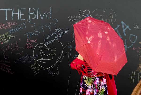 Attendees leave comments on a giant chalk board at The Taste food festival in Hollywood.