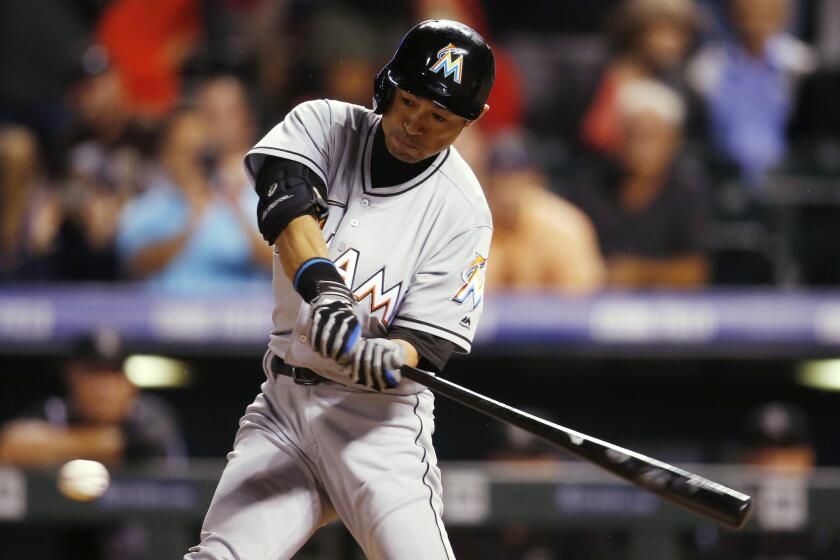 Marlins outfielder Ichiro Suzuki swings at a pitch against the Colorado Rockies during the ninth inning on Aug. 6.