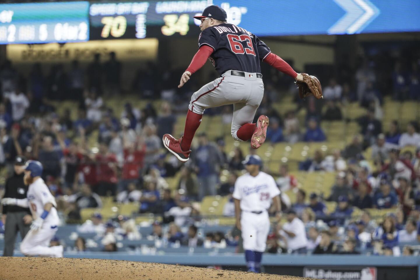 Nationals relief pitcher Sean Doolittle leaps for joy as Dodger third baseman Justin Turner flies out to end the game.