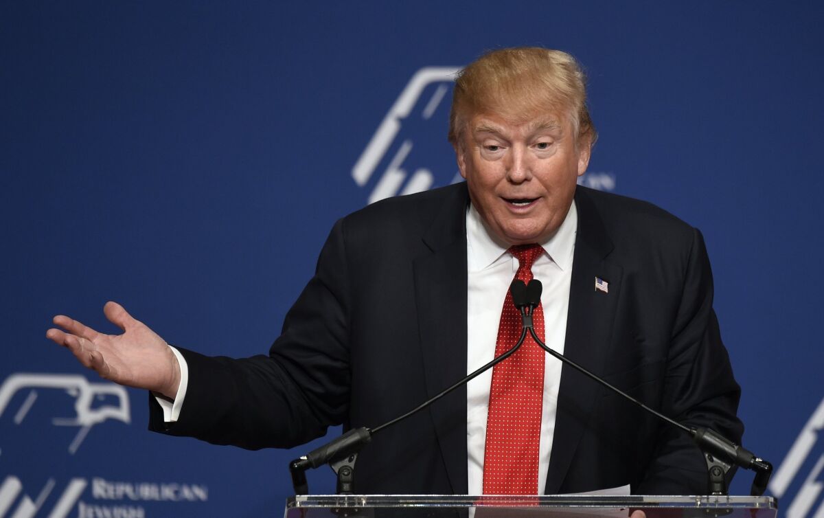 Republican presidential candidate Donald Trump speaks at the Republican Jewish Coalition Presidential Forum in Washington on Dec. 3. His upcoming visit to Israel has stirred controversy there in the wake of call to ban Muslims from entering the United States.
