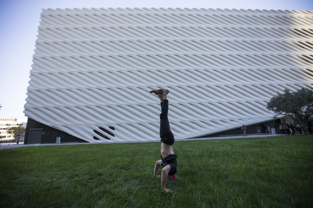 Blakey Olsen, of Laguna Beach, practices yoga in the shade of The Broad art museum.
