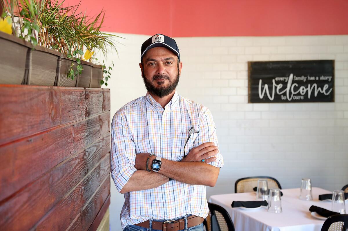 Owner and operator Majid Mahkri stands in the main dining room of Kebab Kurry in Laguna Beach.