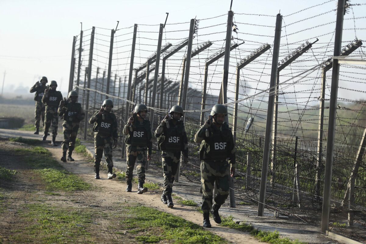 FILE- Indian Border Security Force (BSF) soldiers patrol near the India-Pakistan border fencing at Suchet Garh in Ranbir Singh Pura, Jammu and Kashmir, India, Jan. 23, 2020. For decades, India has tried to thwart Pakistan in a protracted dispute over Kashmir. But in the last two years, policy makers in New Delhi have been increasingly turning their focus to Beijing, in a significant shift in India's foreign policy as the nation celebrates 75 years of independence. (AP Photo/Channi Anand, File)