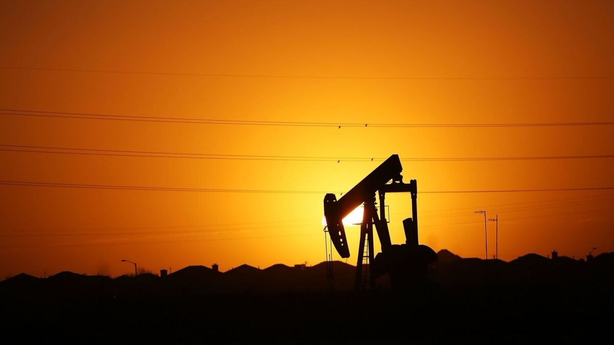 A pumpjack sits on the outskirts of town at dawn in January 2016 in the Permian Basin oil field near Midland, Texas.