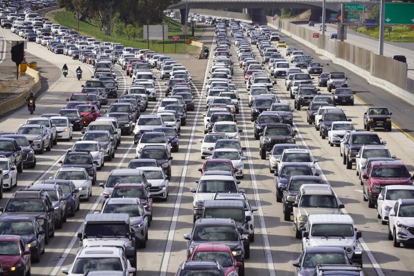 San Diego, California - March 26: Bumper to bumper traffic builds on the 805 and 5 South as Mexico-bound cars line up. Vehicles wait over an hour to head into Mexico. Images from Camino De La Plaza in San Ysidro on Tuesday, March 26, 2024 in San Diego, California. (Alejandro Tamayo / The San Diego Union-Tribune)