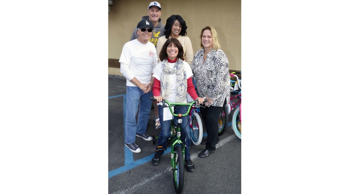 Bike Angels founder Elaine Pease, front center, was supported by former Burbank Park Board member Terre Hirsch, from left, former City Manager Mike Flad, and Cheritta Smith and Alisa Cunningham of BAOR at last week's bike drive.