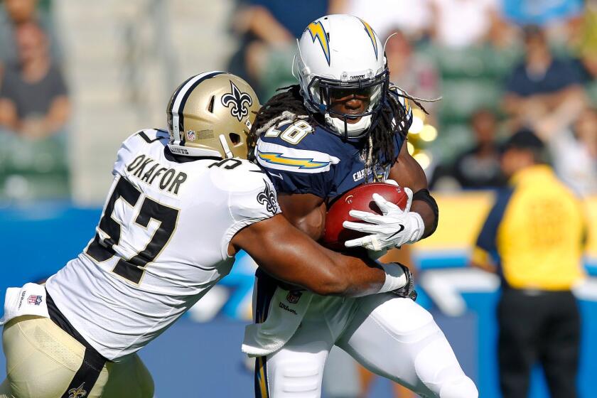 Los Angeles Chargers Chargers running back Melvin Gordon loses 9 yards as he is hit by New Orleans Saints Alex Okafor in the first quarter at the StubHub Center in Carson on Sunday, August 20, 2017. (Photo by K.C. Alfred/The San Diego Union-Tribune)