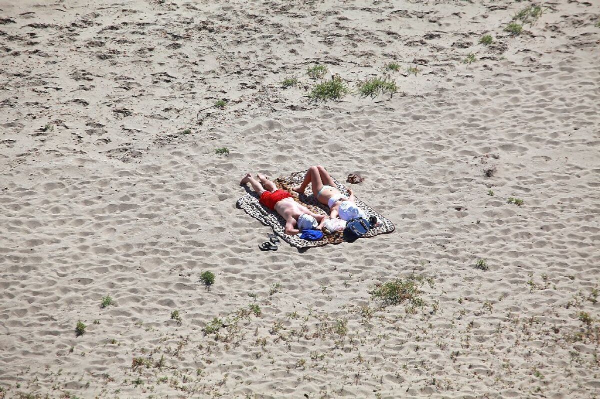 Sunbathers soak up ultraviolet rays at La Piedra State Beach in Malibu. A new report from the CDC says that the incidence of melanoma -- the most deadly form of skin cancer -- has doubled in the U.S. in the last 30 years.
