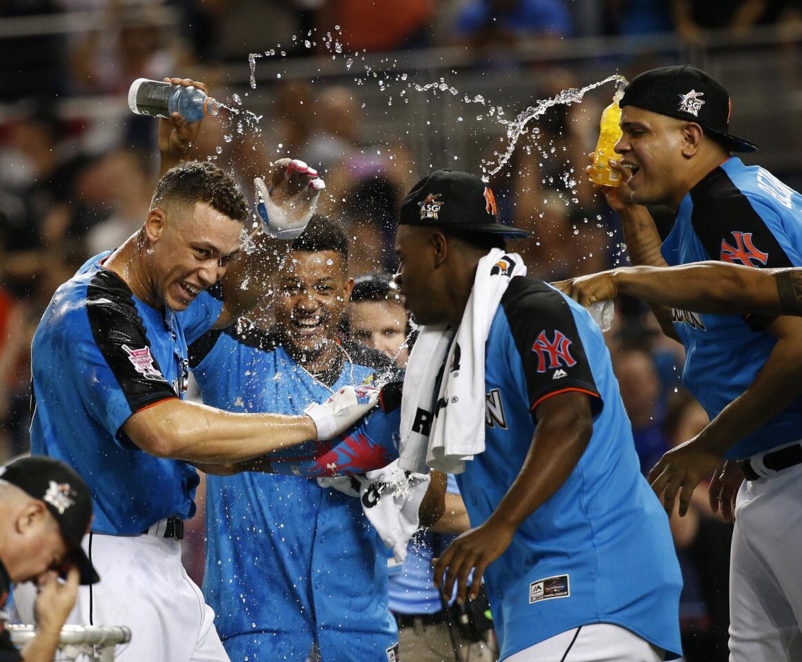 Yankees outfielder Aaron Judge gets doused by American League All-Star teammates after winning the Home Run Derby on Monday night in Miami.