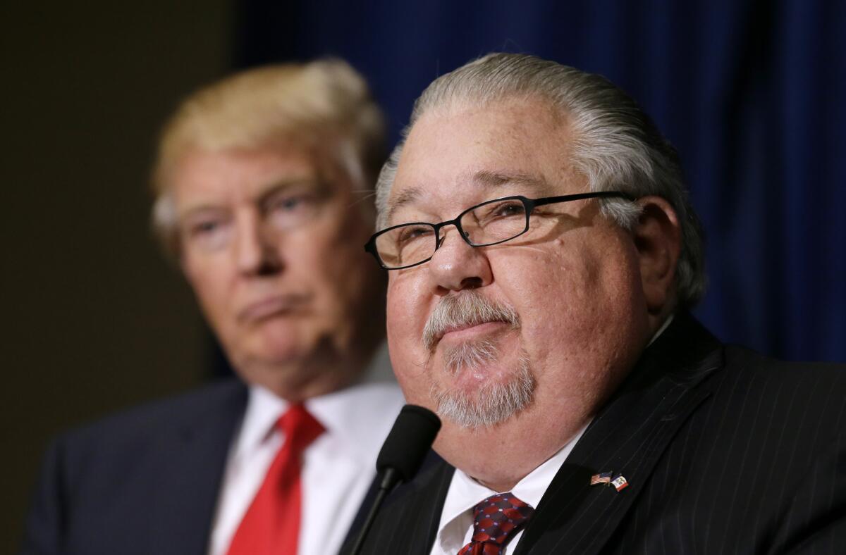 Sam Clovis speaks during a news conference as then-Republican presidential candidate Donald Trump watches before a campaign rally in Dubuque, Iowa, on Aug. 25, 2016.