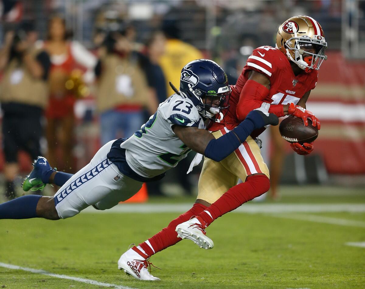 SANTA CLARA, CALIFORNIA - NOVEMBER 11: Emmanuel Sanders #17 of the San Francisco 49ers is tackled by Neiko Thorpe #23 of the Seattle Seahawks in the first quarter at Levi's Stadium on November 11, 2019 in Santa Clara, California. (Photo by Lachlan Cunningham/Getty Images) ***BESTPIX*** ** OUTS - ELSENT, FPG, CM - OUTS * NM, PH, VA if sourced by CT, LA or MoD **