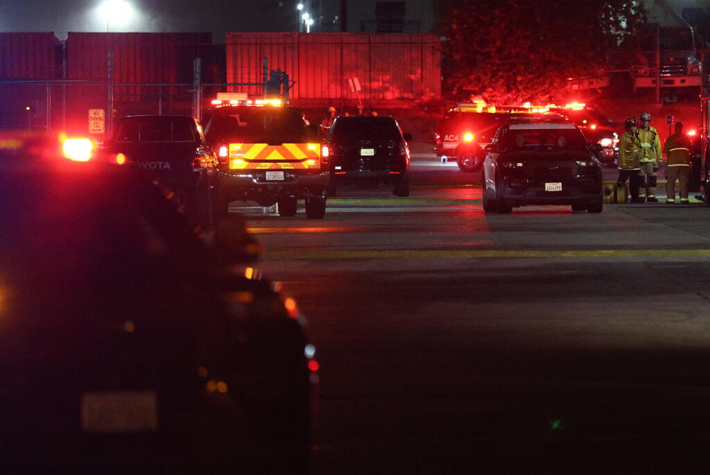 CHATSWORTH, CA - SEPTEMBER 15: Police investigate a helicopter crashed and burst into flames Tuesday night in Chatsworth not far from a serious accident involvi