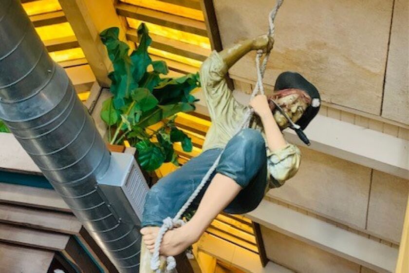 Swashbuckling pirate figures hang from the ceiling at Fiddler's Green.