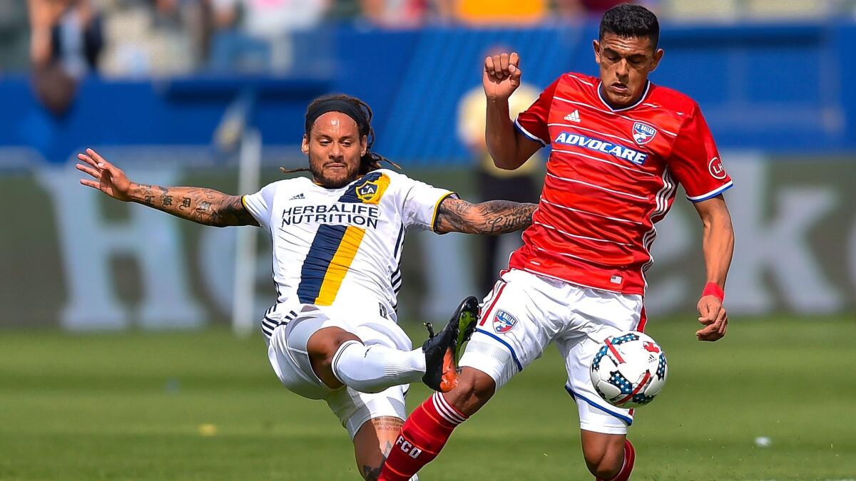 Galaxy midfielder Jermaine Jones, left, kicks the ball away from FC Dallas forward Cristian Colman on March 4.