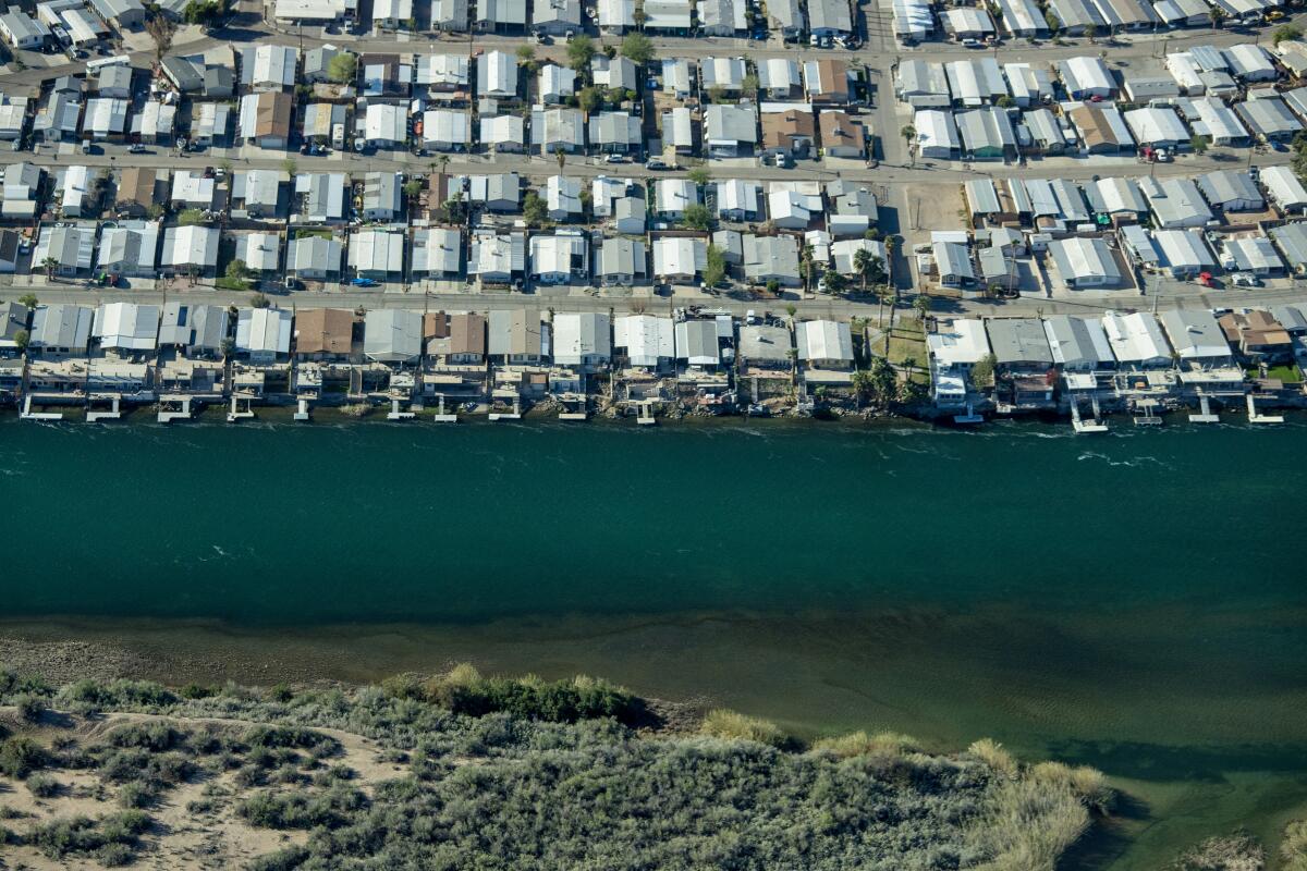 Homes along the Colorado River in Parker, Ariz. Heavy snow this year has boosted the amount of water in the river.