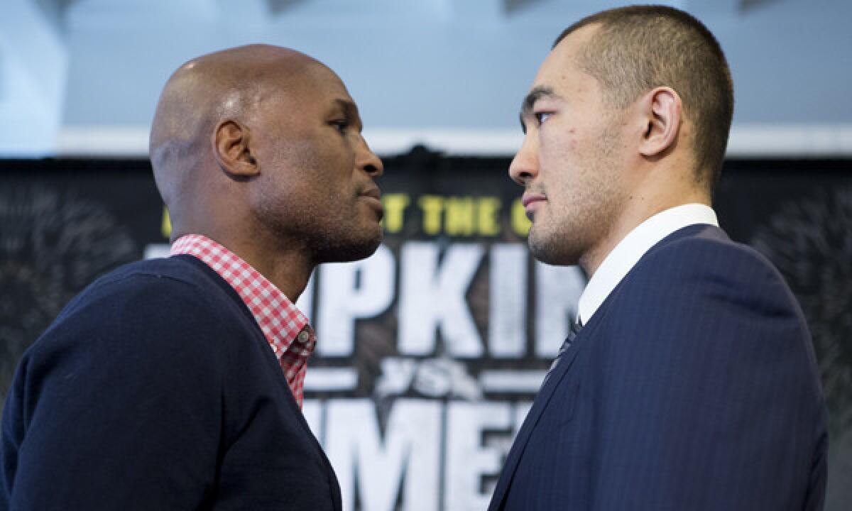 Bernard Hopkins, left, and Beibut Shumenov pose during a news conference Tuesday to promote their light heavyweight unification title bout set for April 19 in Washington.