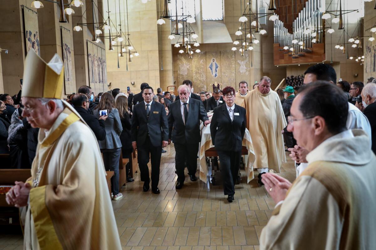 Archbishop José H. Gómez left, leads the recessional at the conclusion of the funeral mass