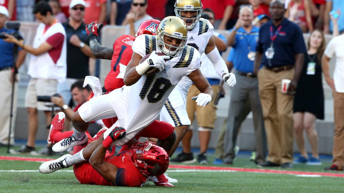 UCLA receiver Thomas Duarte scores a touchdown against Arizona on a 35-yard pass from Josh Rosen in the first quarter Saturday evening in Tucson.