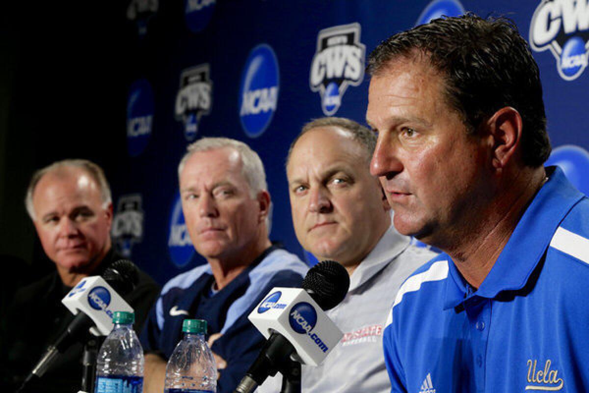 UCLA Coach John Savage, right, speaks during a news conference alongside coaches, from left, Louisiana State's Paul Mainieri, North Carolina's Mike Fox and North Carolina State's Elliott Avent at TD Ameritrade Park in Omaha.