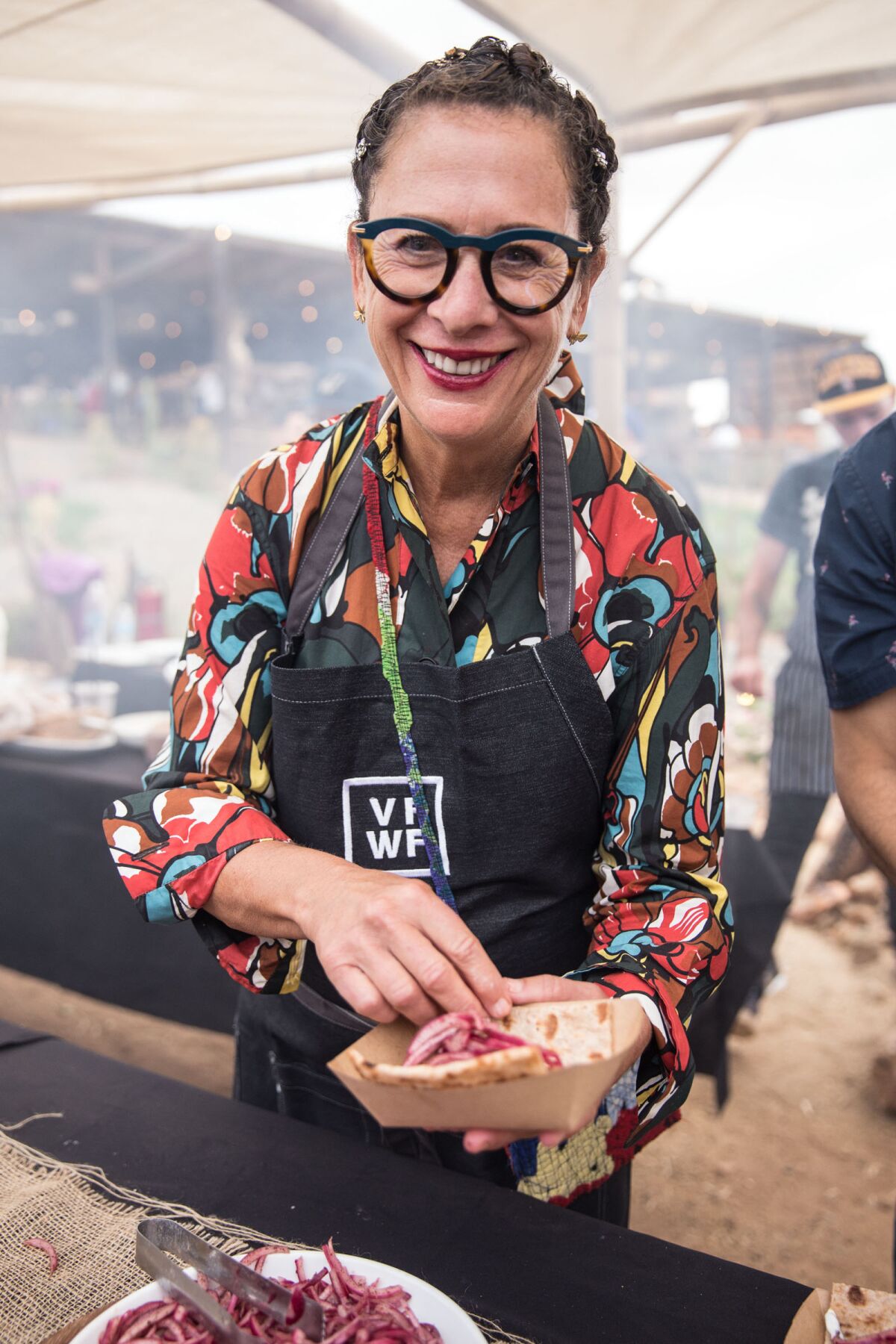 Valle Food & Wine Fest co-founder Nancy Silverton prepares a food dish for a festival-goer at the annual event in Baja's Valle de Guadalupe.
