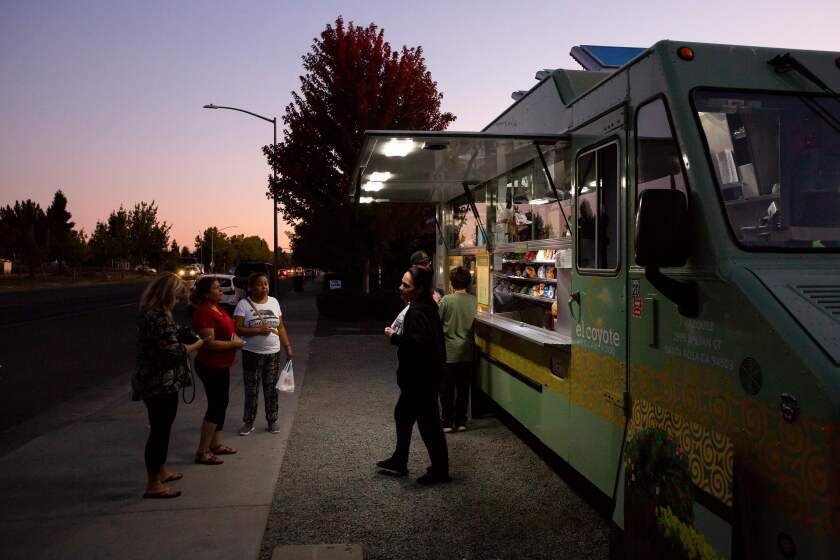 Local residents pick up meals from El Coyote food truck, one of the few food trucks open in the area, in Sonoma, California, on October 9, 2019, after the Pacific Gas & Electric (PG&E) utility company began planned power outages. - Rolling blackouts set to affect millions of Californians began on October 9 as a utility company started switching off power to an unprecedented number of households in the face of hot, windy weather that raises the risk of wildfires. (Photo by Brittany Hosea-Small / AFP) (Photo by BRITTANY HOSEA-SMALL/AFP via Getty Images) ** OUTS - ELSENT, FPG, CM - OUTS * NM, PH, VA if sourced by CT, LA or MoD **