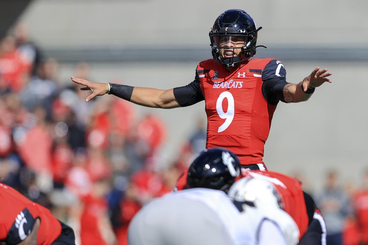 Cincinnati quarterback Desmond Ridder signals prior to a play at the line of scrimmage.