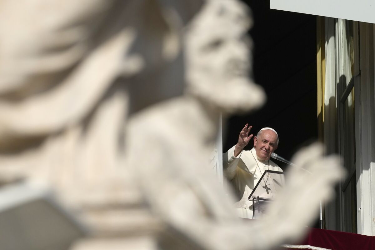 Pope Francis waves during the Angelus noon prayer from the window of his studio overlooking St. Peter's Square, at the Vatican, Sunday, Nov. 7, 2021. (AP Photo/Alessandra Tarantino)