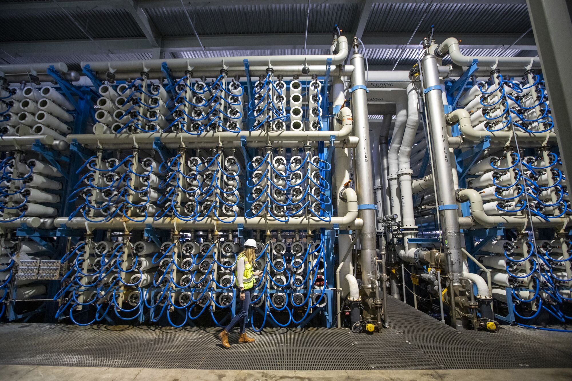 Michelle Peters walks in the reverse osmosis building, at the Claude "Bud" Lewis Carlsbad Desalination Plant.