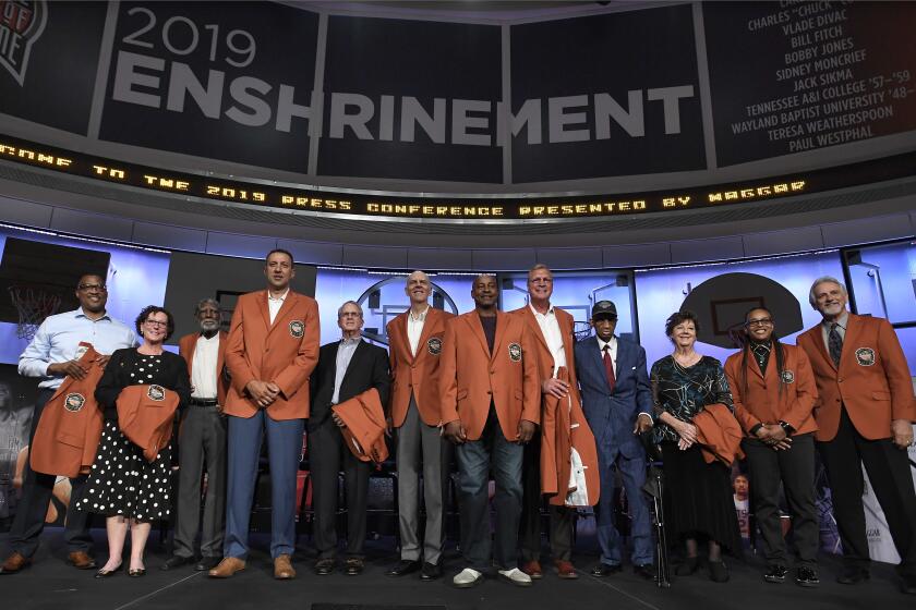 The class of 2019 inductees into the Basketball Hall of Fame, from left to right, Chuck Cooper III, accepting on behalf of his late father Chuck Cooper, Susan Braun, accepting on behalf of her later father Carl Braun, Al Attles,Vlade Divac, Ron Coville accepting on behalf of his father-in-law, Bill Fitch, Bobby Jones, Sidney Moncrief, Jack Sikma, Dick Barnett for Tennessee A&I, Linda Price for Wayland Baptist, Teresa Weatherspoon, and Paul Westphal, pose for a photo during a news conference at the Naismith Memorial Basketball Hall of Fame, Thursday, Sept. 5, 2019, in Springfield, Mass. (AP Photo/Jessica Hill)